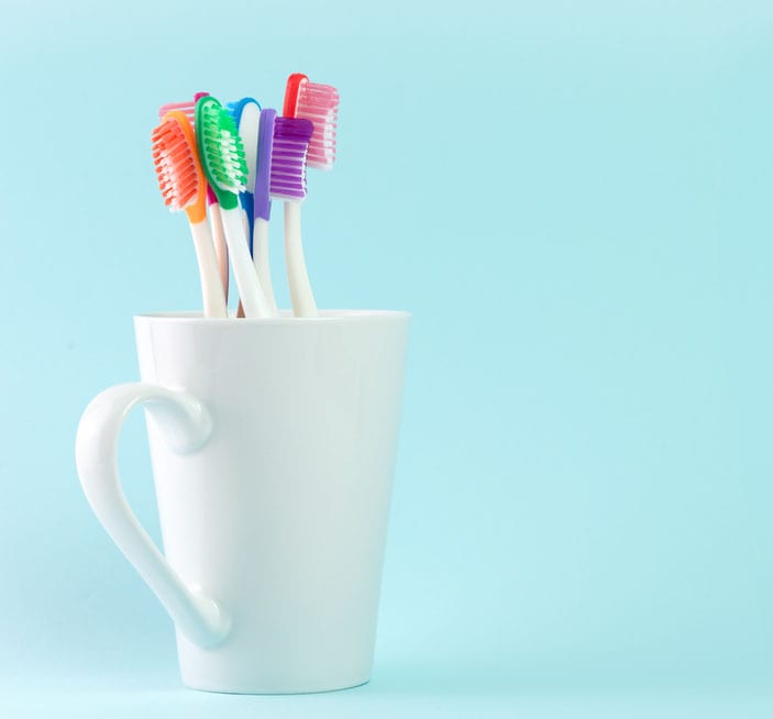 A cup of toothbrushes.