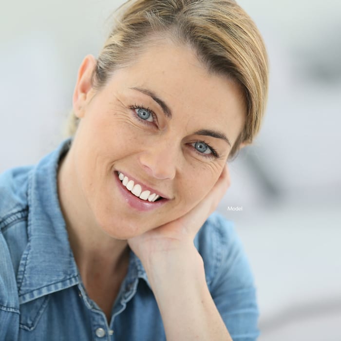Woman resting her chin on her hands