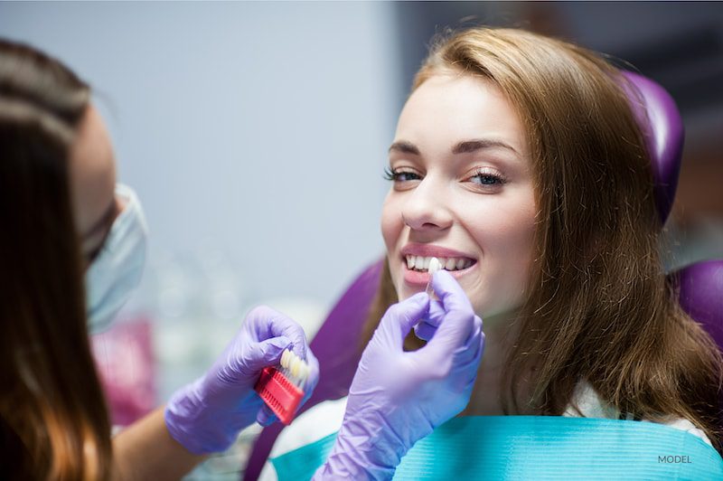 Dentist curing a woman patient in the dental office in a pleasant environment.