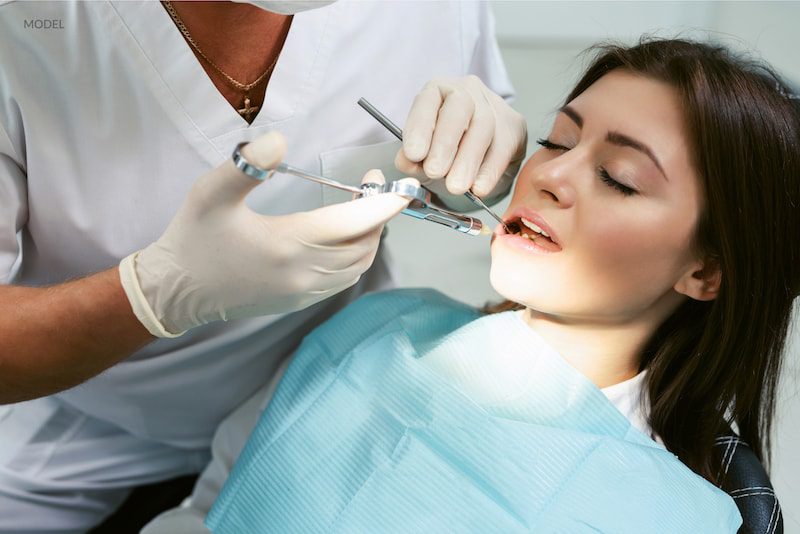 Woman undergoing a dental treatment while sedated.
