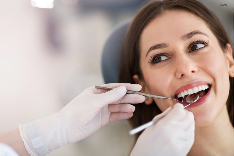 Woman getting her teeth checked by her dentist.