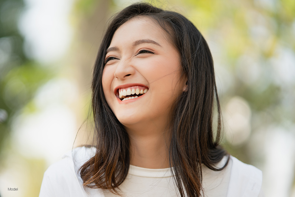 Young woman outside, smiling