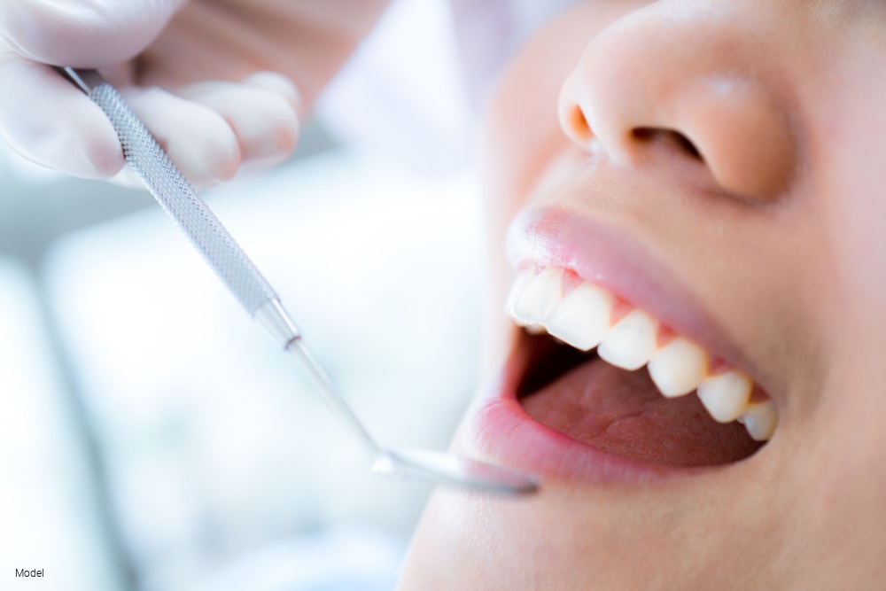 Close-up of young female having her teeth examinated