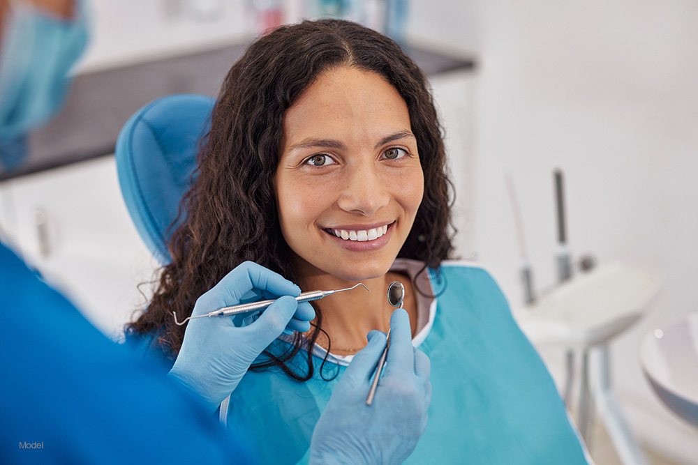Woman with curly hair at the dentist