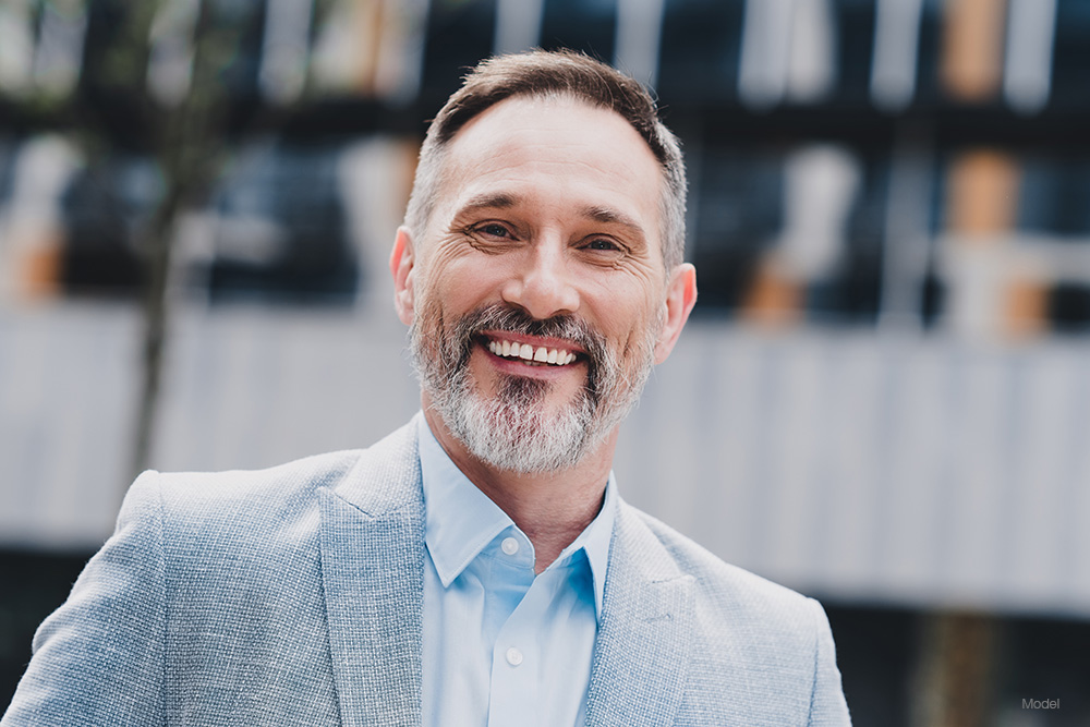 Mature man in a suit smiling